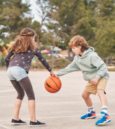Teen friends playing basketball together